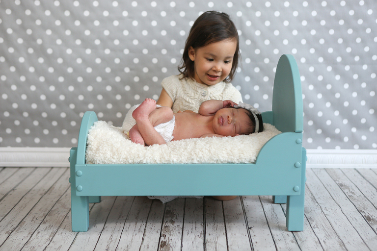 Newborn Baby In Doll Bed With Sister