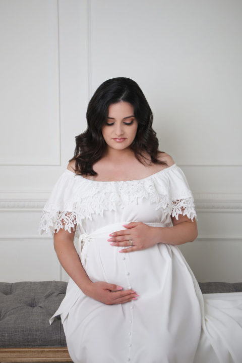 Los Angeles Studio Maternity session, white molding wall, pregnancy mother in white dress.