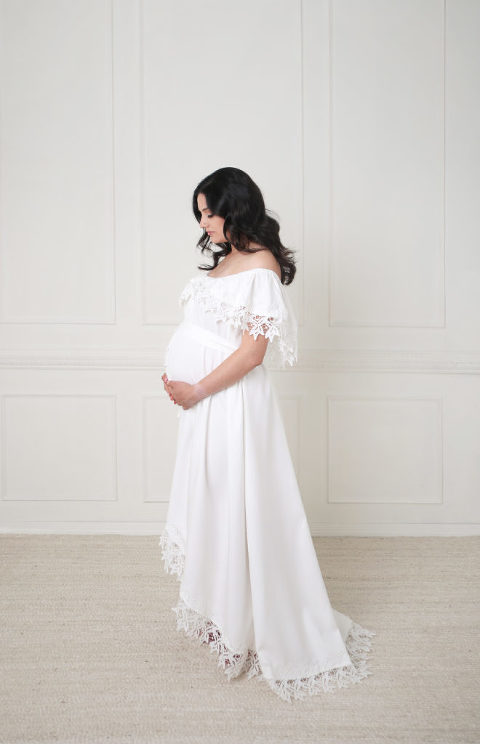 Los Angeles Studio Maternity session, white molding wall, pregnant mother posing in white dress.