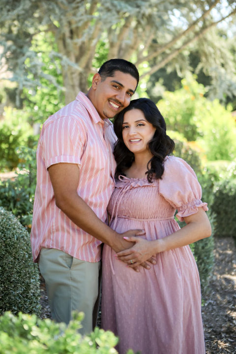 Pregnancy couple in pink in garden or park setting, Los Angles Maternity Session. 