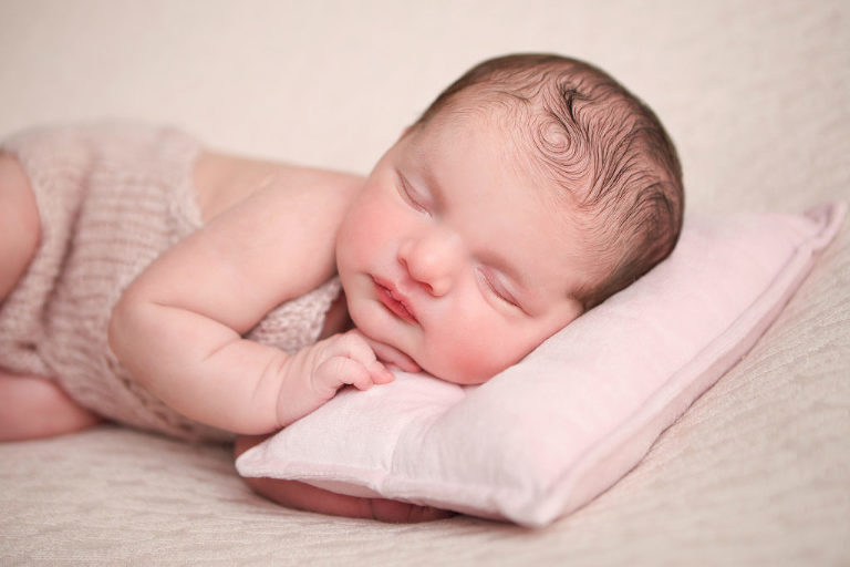 Newborn baby girl with cowlick in hair. 