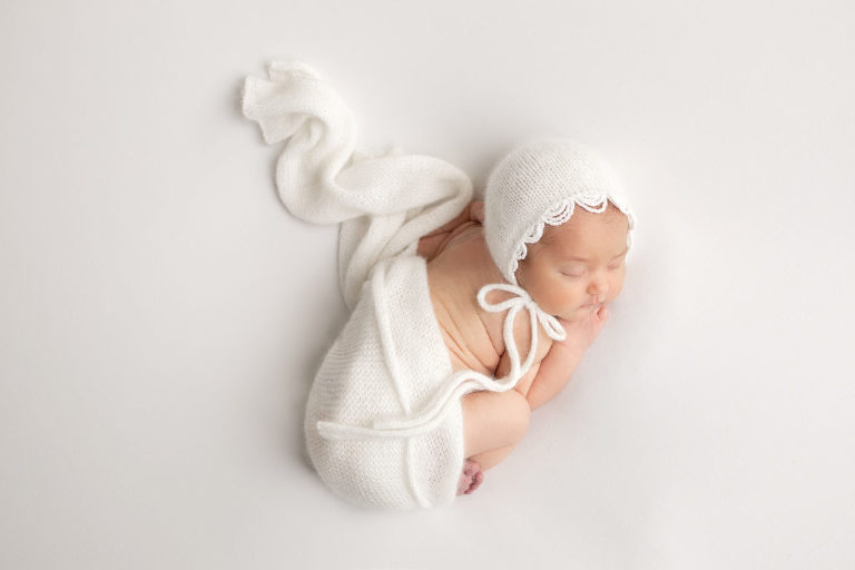 Newborn Baby Girl in white beaded hat on Posing Table, Diana Henderson Photography, Los Angeles Newborn Photography